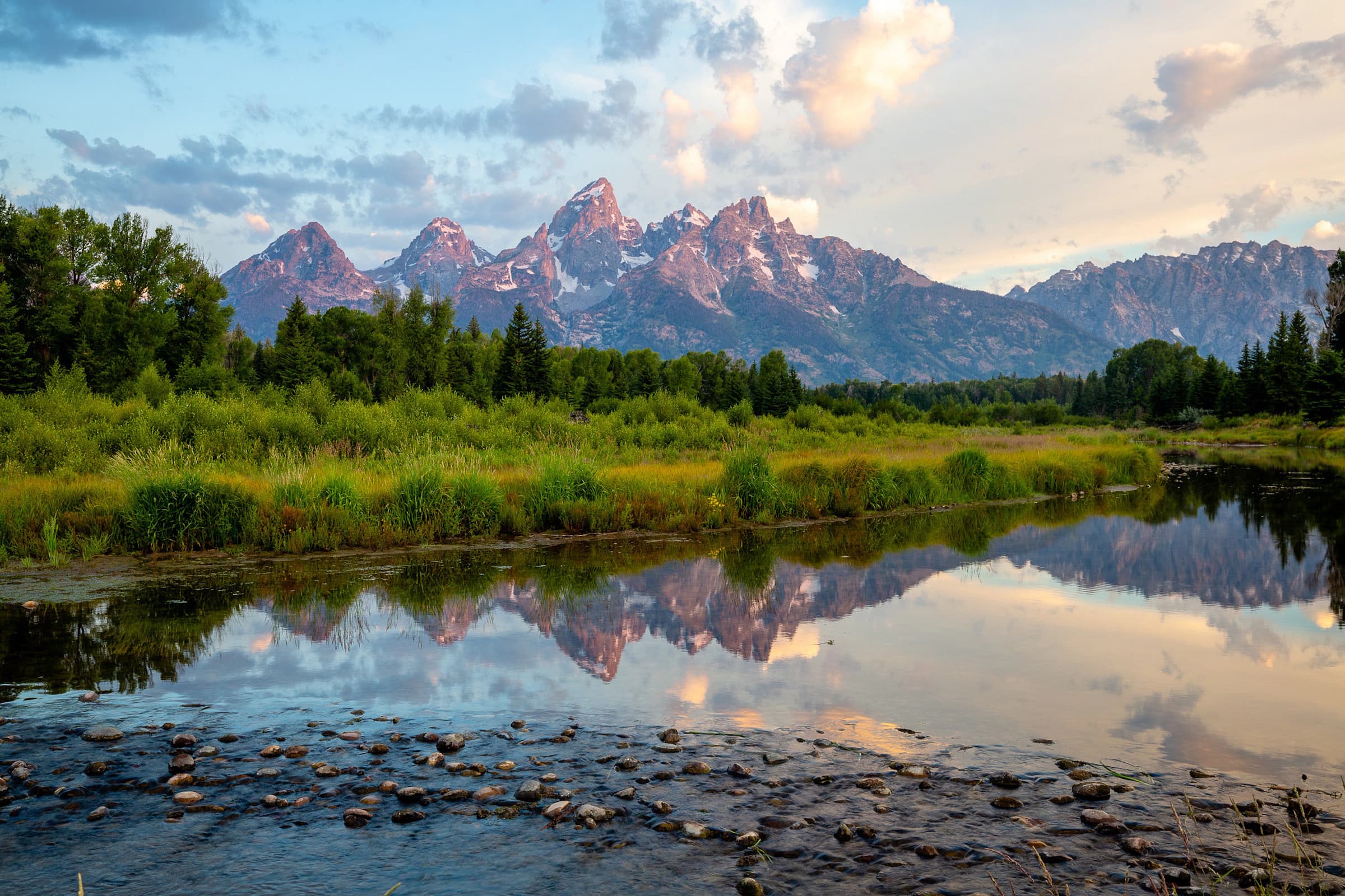 A lake in front of a mountain in the distance in Jackson Hole, Wyoming.