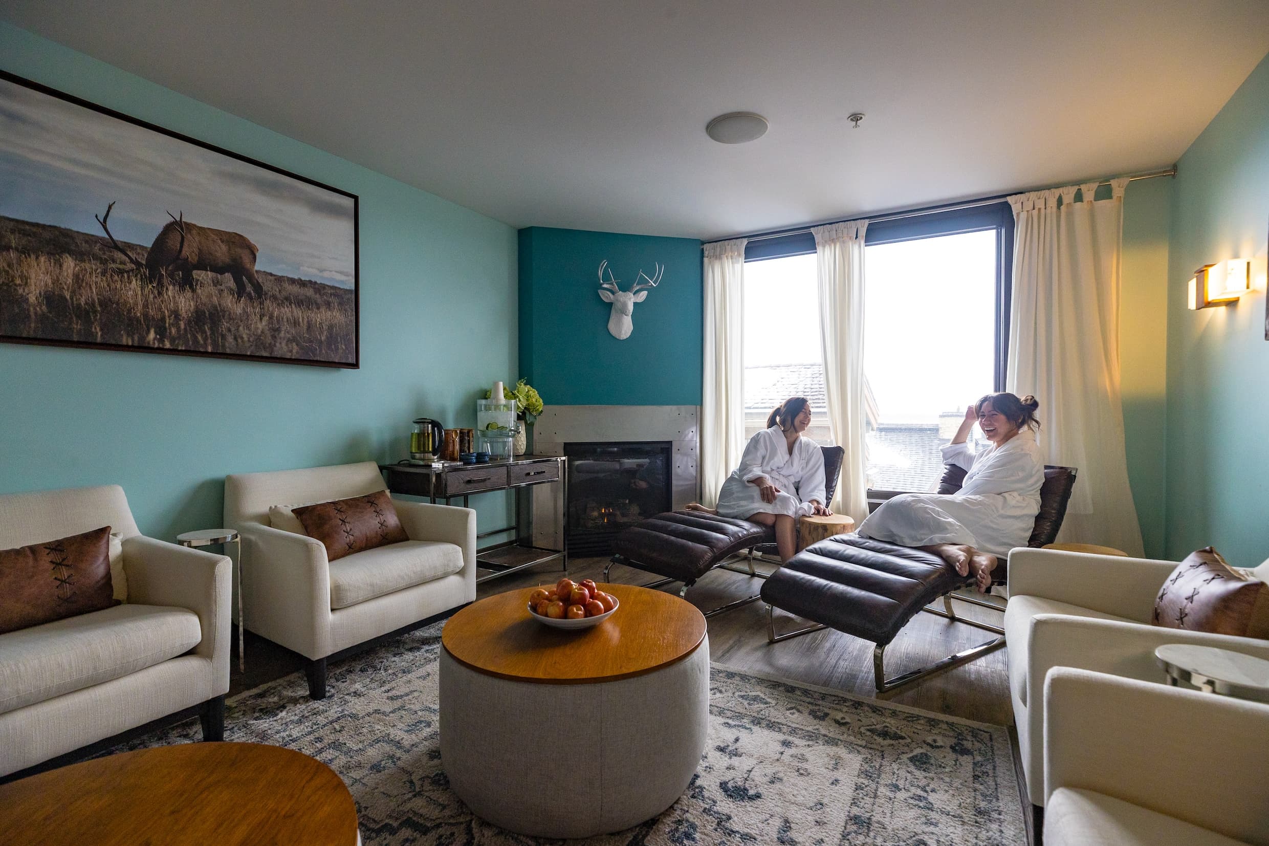 Two women laugh and socialize in the Chill Spa lounge at Hotel Terra Jackson Hole.