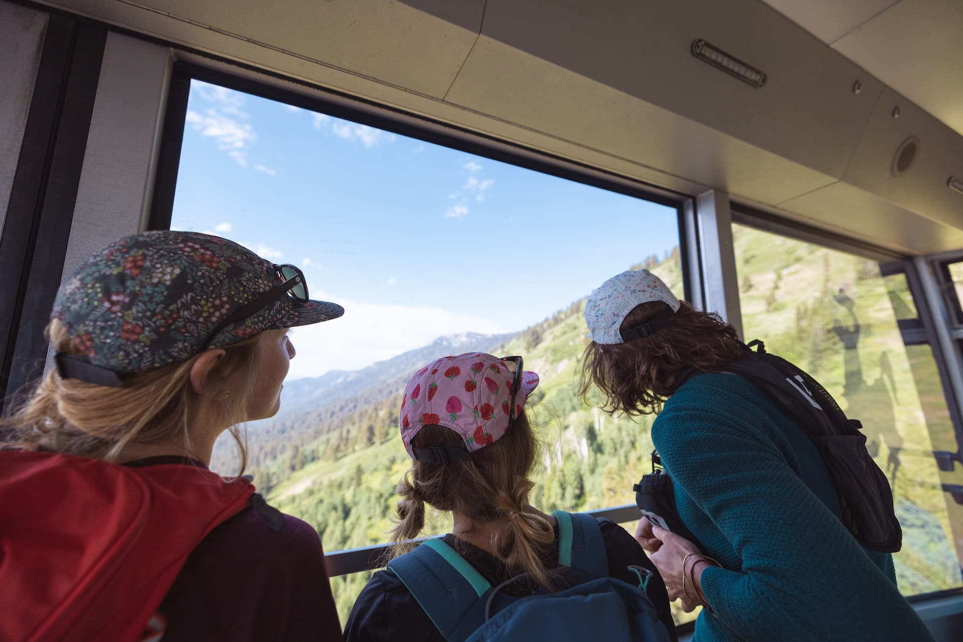 Children looking out of the window on the Jackson Hole tram ride during the summer