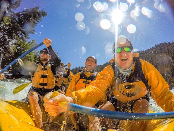A boat of paddlers whitewater rafting with Mad River Boat trips near Jackson Hole, Wyoming.