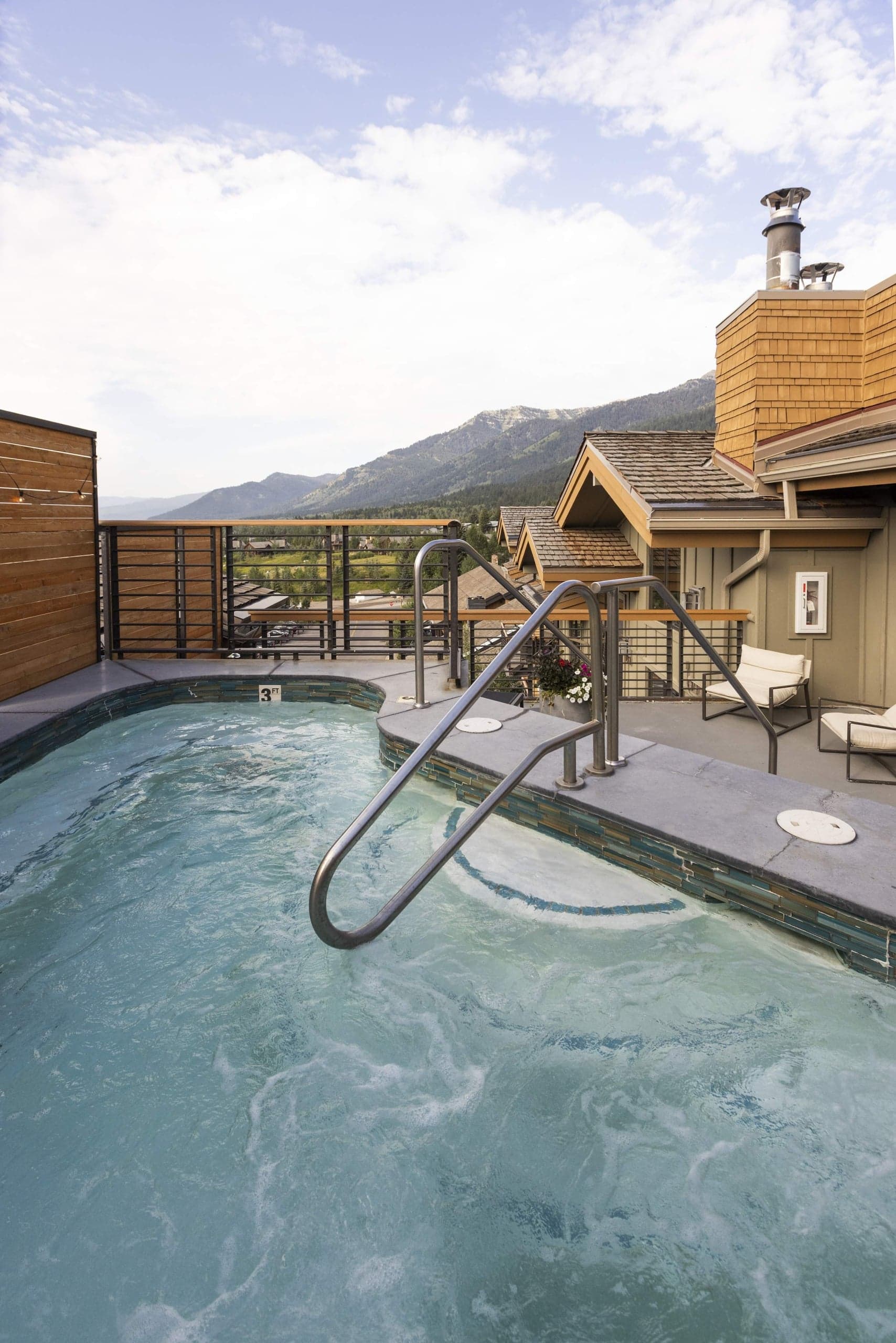 Outdoor hot tub with mountain views at Hotel Terra Jackson Hole