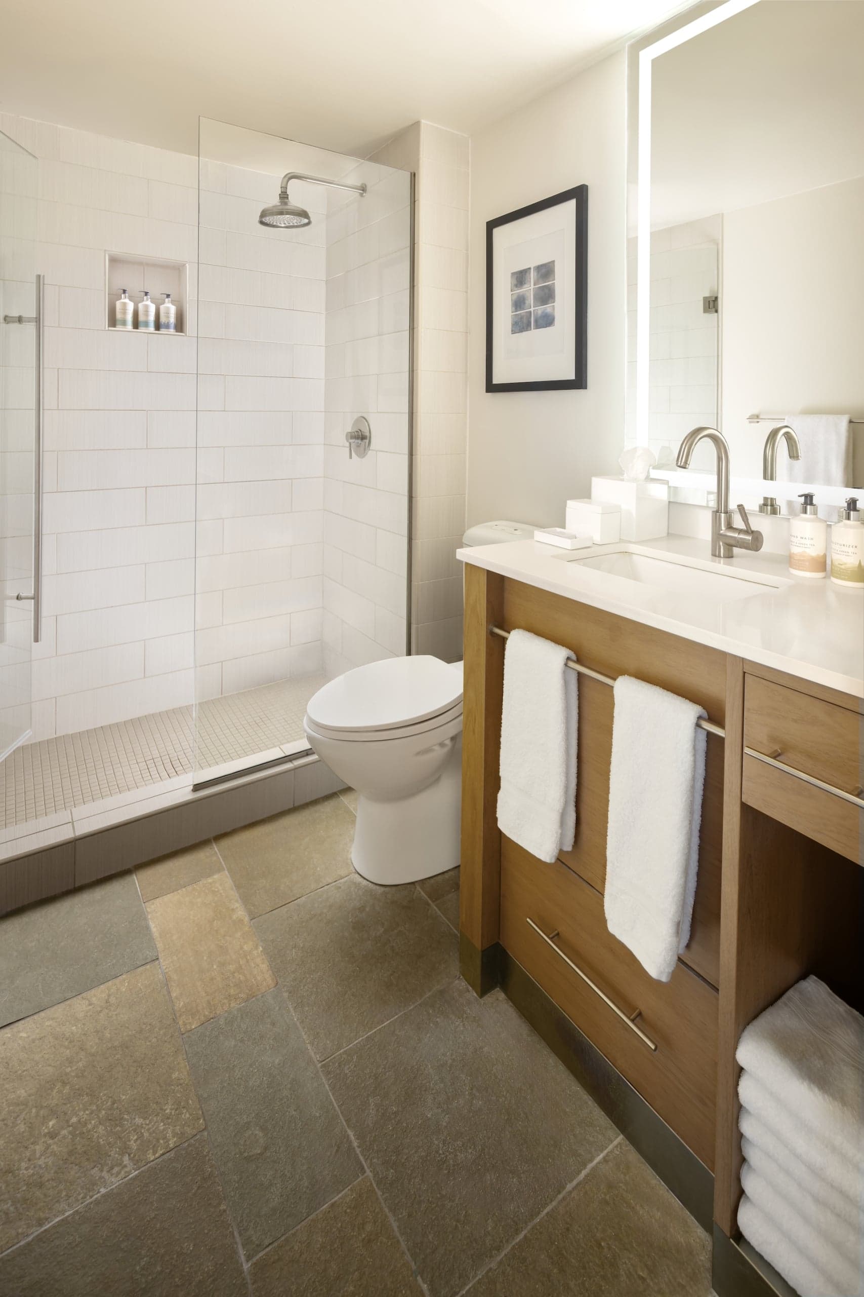 Shower, and vanity in a room at Terra Hotel
