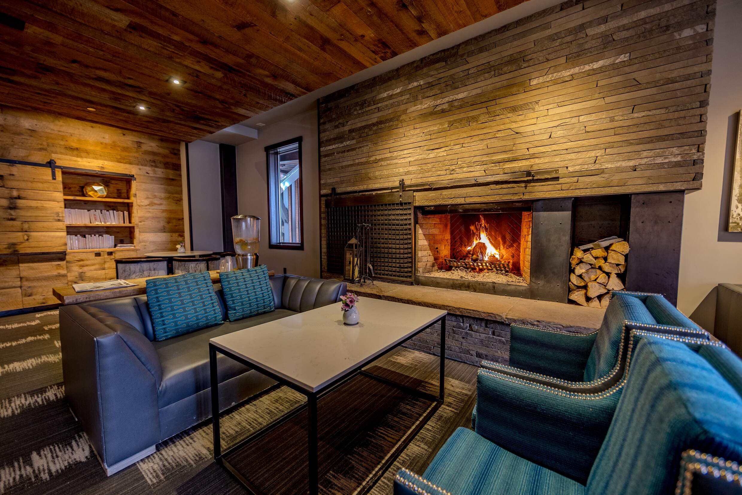 Wood burning fireplace and seating area in the lobby of Hotel Terra in Jackson Hole, Wyoming.
