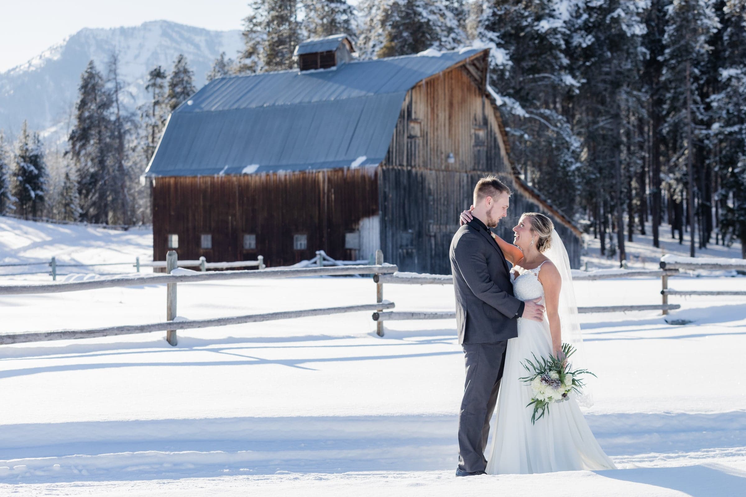 Bride and groom wedding photo outside Gray Barn in Winter in Jackson Hole, Wyoming