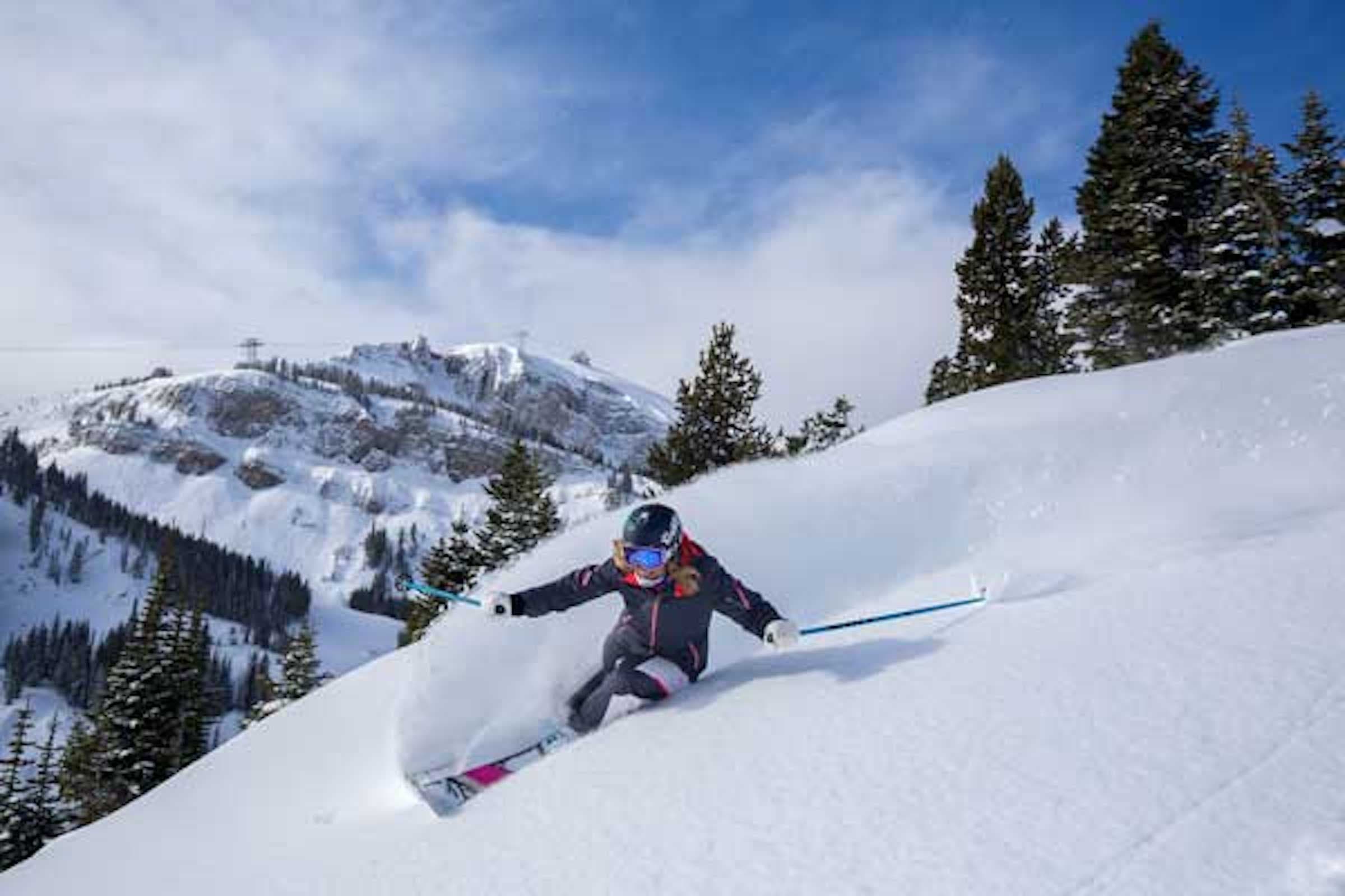 A skiier takes a turn carving the snow going down the run at Jackson Hole Mountain Resort.
