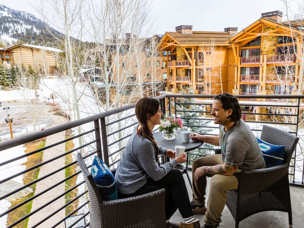 Couple Having Coffee On The Balcony