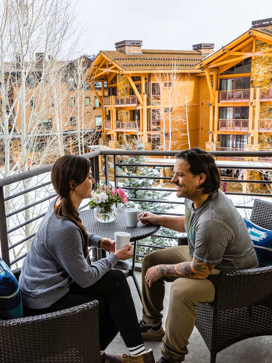 Couple Drinking Coffee On The Balcony